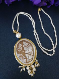 Elegant necklace with original shell cameo from Torre del Greco Italia depicting flowers, surrounded by small natural white beads, and small final cluster beads. The cameo measures length 6 cm / width 4 cm. Necklace length measures 60 cm. Authentic cameo. With gift box. White Victorian Pearl Necklace, Elegant White Cameo Necklace, Cameo Necklace, Elegant Necklace, Elegant Necklaces, White Beads, Necklace Length, Pearl White, Necklace Lengths