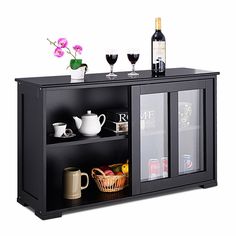 an entertainment center with two wine glasses and bottles on the top shelf next to it