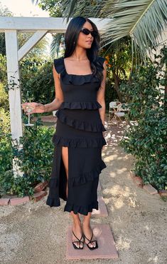 This fitted midi dress is as flattering as it is comfortable! Ruffled to perfection, this black dress isn't your everyday midi! A square neckline and tank top straps lay the foundation for a simple silhouette, while dainty details including a slit to elevate it. Show up and show out at all this seasons events. Black Wedding Guest Dress Summer, Black Cocktail Dress Classy, Black Ankle Length Dress, Black Tie Wedding Guest Dresses, Black Wedding Guest Dresses, Black Tie Wedding Guest, Black Tie Wedding Guest Dress, Greta Dress, Black Summer Dress