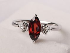 Welcome to my shop, you can find many beautiful gemstone jewelry here, and you also can ask for customized service. Main Stone: 5*10 mm marquise cut natural garnet Accent Stones: cz Metal: 925 sterling silver plated with rhodium. I also can provide metal options such as 14k solid yellow/white/rose gold Setting: prong setting More rings please go to my shop home: https://www.etsy.com/shop/XCjewelryStudio?ref=hdr_shop_menu It's a perfect gift for who born in June(birthstone),it's quite comfortable Marquise Garnet Ring, Garnet Wedding Rings Silver, Moon Wedding Ring, Unique Garnet Ring, Meteorite Engagement Ring, Meaningful Rings, Marquise Wedding Ring, Garnet Wedding Rings, Garnet Wedding