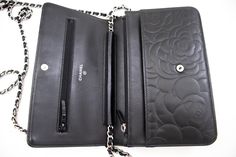 An CHANEL Black Camellia Embossed Wallet On Chain WOC Shoulder Bag k68 This item is Contemporary. The year of manufacture would be 2012.This browser is not supportedConditions & RatingsOutside material: LambskinColor: BlackClosure: SnapHardware and chain: Silver-ToneMade in FranceSerial sticker: AttachedSerial #: 17993335 (Same number on the sticker and the card.)Manufactured in 2013.Comes with: ity card, BoxOverall: 8 of 10 - The outside is in excellent condition with minimal signs of use only. Jimmy Choo Sunglasses, Wallet On Chain, Fendi Shoes, Chain Silver, Trending Handbag, Chanel Black, Sunglasses Branding, Chanel Shoes, Fendi Bags