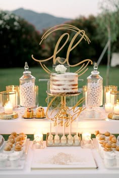 a table with desserts and candles on it