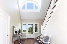 an entry way with stairs and a rug on the floor