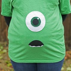 a woman wearing a green shirt with an eyeball on it