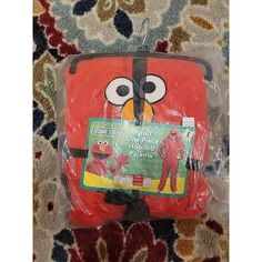 a red suitcase with an angry bird on it's front and back sides, wrapped in plastic