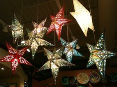 christmas lights hanging from the ceiling in a room with decorations on it's sides