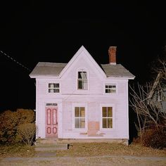 an old white house with a red door