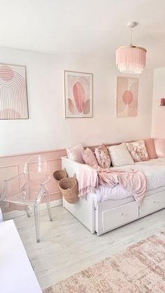 a living room filled with furniture and pink accents on the walls, including a couch