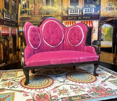 a pink couch sitting on top of a rug