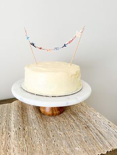 a white cake sitting on top of a wooden table