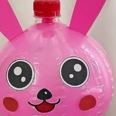 an inflatable balloon shaped like a pink bunny with big eyes and ears on it's head