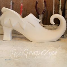 a white ceramic shoe shaped like an elephant