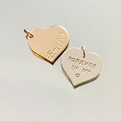 Available in sterling silver and gold filled, this 3/4" heart can be hand stamped with names, dates, short phrase, or certain symbols.  I have several symbols that fit on this larger charm.   Comes with a jump ring, large enough to slide onto most chains. Write in the "Personalization" Box what you would like on your charm, in which font (see last picture for font options), and whether you would like the letters darkened or left natural (will be left natural if not specified otherwise). If you have any additional requests they can also be written there and I'll see what can be done! Please allow up to one week for your piece to be crafted! Personalized Heart Charms For Anniversary, Personalized Sterling Silver Heart Pendant Charms, Personalized Hand Stamped Heart Necklace, Large Heart, Silver And Gold, Jump Rings, Last Minute Gifts, Heart Charm, Hand Stamped