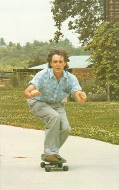 a man riding a skateboard down a sidewalk