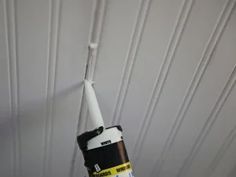 a black and white toothbrush sticking out of the ceiling