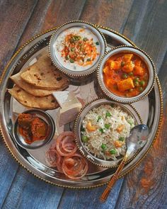 a silver plate topped with different types of food