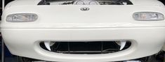 the front end of a white sports car