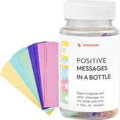 a bottle filled with lots of different colored papers