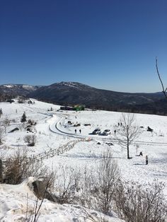 a snowy field with cars parked on it