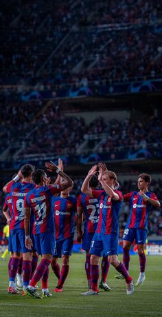 a group of men standing on top of a soccer field