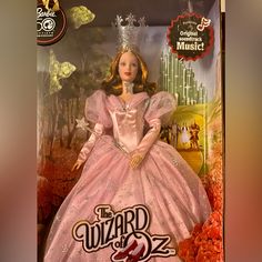 the wizard of oz barbie doll is in its pink gown and tiara, complete with accessories