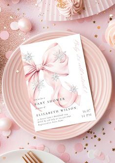 a baby shower card on a pink plate