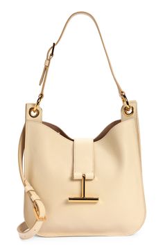 Signature T-shaped hardware brings discreet branding to an iconic Tom Ford top-handle bag crafted of beautifully grained leather. A detachable strap that easily converts for shoulder to crossbody wear offers another carrying option for styling versatility. Magnetic-snap tab closure Adjustable top-carry handle; removable, adjustable shoulder strap Interior zip pocket Lined Leather Made in Italy Designer Handbags Modern Tan Shoulder Bag With Detachable Handle, Tan Top Handle Bucket Bag With Gold-tone Hardware, Modern Tan Shoulder Bag With Detachable Strap, Chic Tan Shoulder Bag With Handle Drop, Timeless Tan Shoulder Bag With Gold-tone Hardware, Tan Satchel With Palladium Hardware, Timeless Tan Shoulder Bag With Branded Hardware, Workwear Shoulder Bag With Gold-tone Hardware And Round Handle, Workwear Shoulder Bag With Round Handle And Gold-tone Hardware