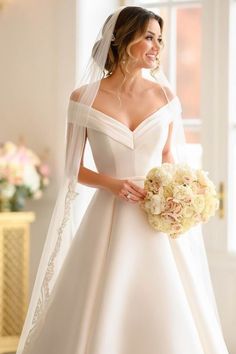 a woman in a wedding dress holding a bouquet