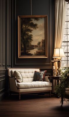 a living room filled with furniture and a painting hanging on the wall over a window