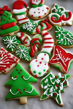 many decorated christmas cookies on a table