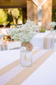 a vase filled with baby's breath sitting on top of a table