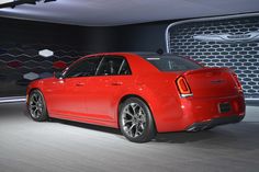 the rear end of a red car on display