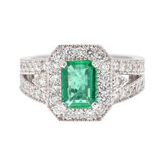 Stunning Vintage Inspired Emerald Cut Emerald Diamond Ring! This Emerald ring is absolutely gorgeous. The center is an Emerald Cut Emerald which weighs 1.17 carats and measures in at 6mm x 8 mm. The Emerald is GIA Certified, GIA Cert Number: 6214083422 and can be verified on the GIA website. It is surrounded by 48 Round Cut Diamonds weighing 1.22 carats (Clarity: VS, Color: H). The total carat weight is 2.39 carats. The ring is curated in 18K White Gold and weighs approximately 6.0 grams. It is Retro Engagement Rings, Timeless Ring, Ruby Diamond Rings, Modern Engagement Rings, Emerald Diamond Ring, Estilo Art Deco, Statement Ring Silver, Halo Diamond Ring, White Gold Ring