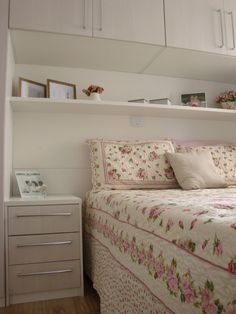 a bed sitting in a bedroom next to a white dresser with drawers on top of it