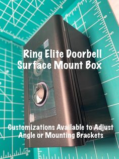 a black box sitting on top of a cutting board with the words ring ette doorbell surface mount box