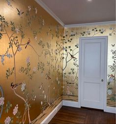 the wallpaper in this room has birds and flowers painted on it, along with an open door