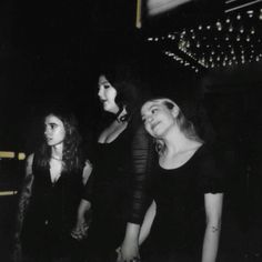 black and white photograph of three women standing next to each other