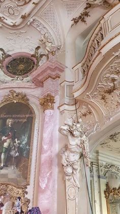 an ornately decorated room with paintings on the walls and ceiling, along with statues