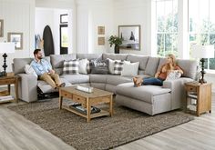 a man and woman sitting on a couch in a living room