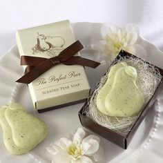 a white plate topped with two pieces of cake next to a box of soaps