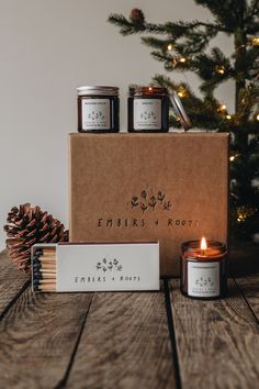 the candle and box are sitting next to each other on top of a wooden table