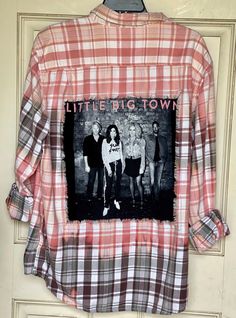 This is ONE OF A KIND Little Big Town flannel shirt. Upcycled/Bleached/Distressed Long sleeve Size Men's XL 100% Cotton This particular flannel has two pockets on the front side of the shirt and is a long sleeve button up. An original Little Big Town concert tee has been sewn into the back of the flannel. The flannel is frayed around the tee, trimming it out, giving it distressed/vintage style look. And the flannel has been bleach.  All my shirts are A ONE OF A KIND. They are all upcycled and previously owned so there will be signs of wear and tear. But this is what make each one unique in its own way and for sure makes them the most comfortable.  *NOTE: If your going to wear this as a oversized jacket it's recommended that you buy a size bigger than you would normally wear. Here are some Band Clothes, Distressed Long Sleeve, Little Big Town, Big Town, Band Outfits, Concert Outfit Ideas, Concert Tees, Vintage Plaid, Oversized Jacket