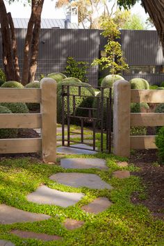 a stone path leading to a wooden gate