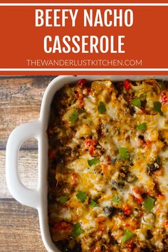 beefy nacho casserole in a white baking dish on a wooden table