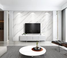 a modern living room with white furniture and marble wallpaper, along with a flat screen tv mounted on the wall