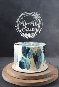 a cake with frosting that says more than brown on top and snowflakes around it