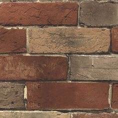 an old brick wall with red and brown bricks