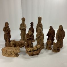 a group of carved wooden figurines sitting next to each other