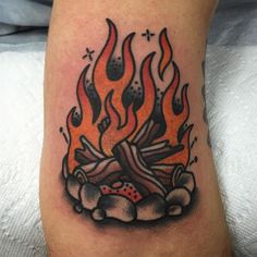 a tattoo with a fire and some dices on it