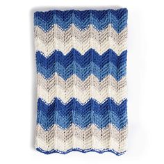 a blue and white knitted blanket sitting on top of a table